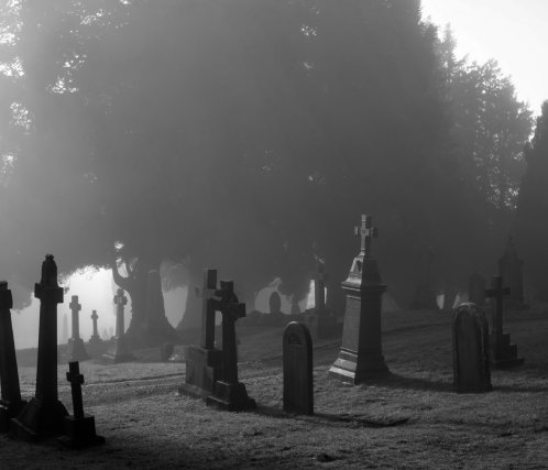 A black and white photo of a graveyard.
